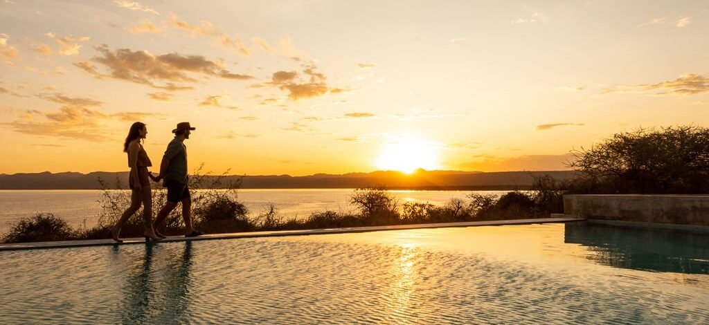 Honeymoon couple watching sunset at Lake Manyara during Tanzania honeymoon safari