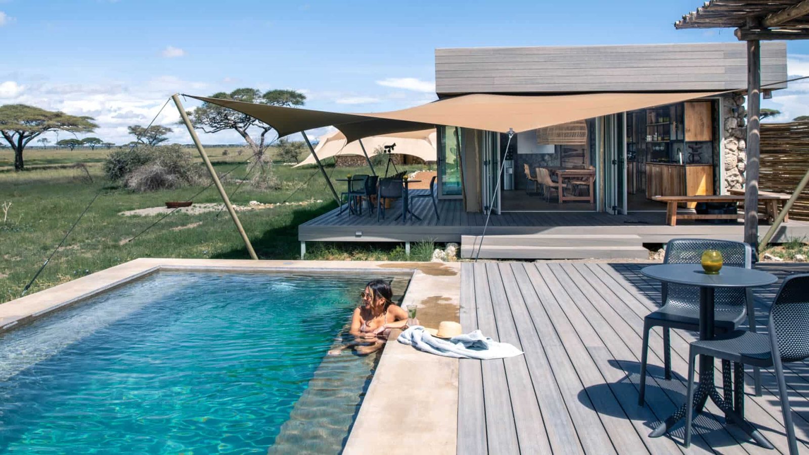 Woman relaxing at infinity pool during Tanzania honeymoon in Serengeti - Retreat at Namiri
