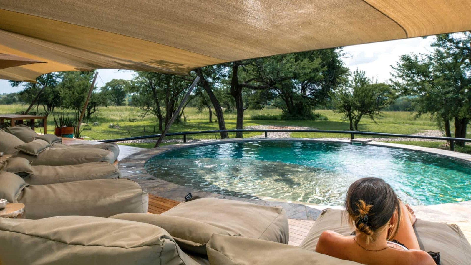 Luxury tented safari camp guest enjoying panoramic views of Tanzania’s untouched wilderness.